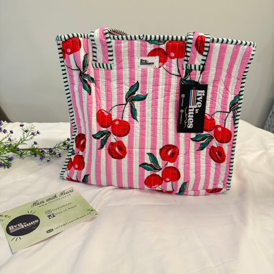 Pink and white striped fabric with cherry pattern on a white background