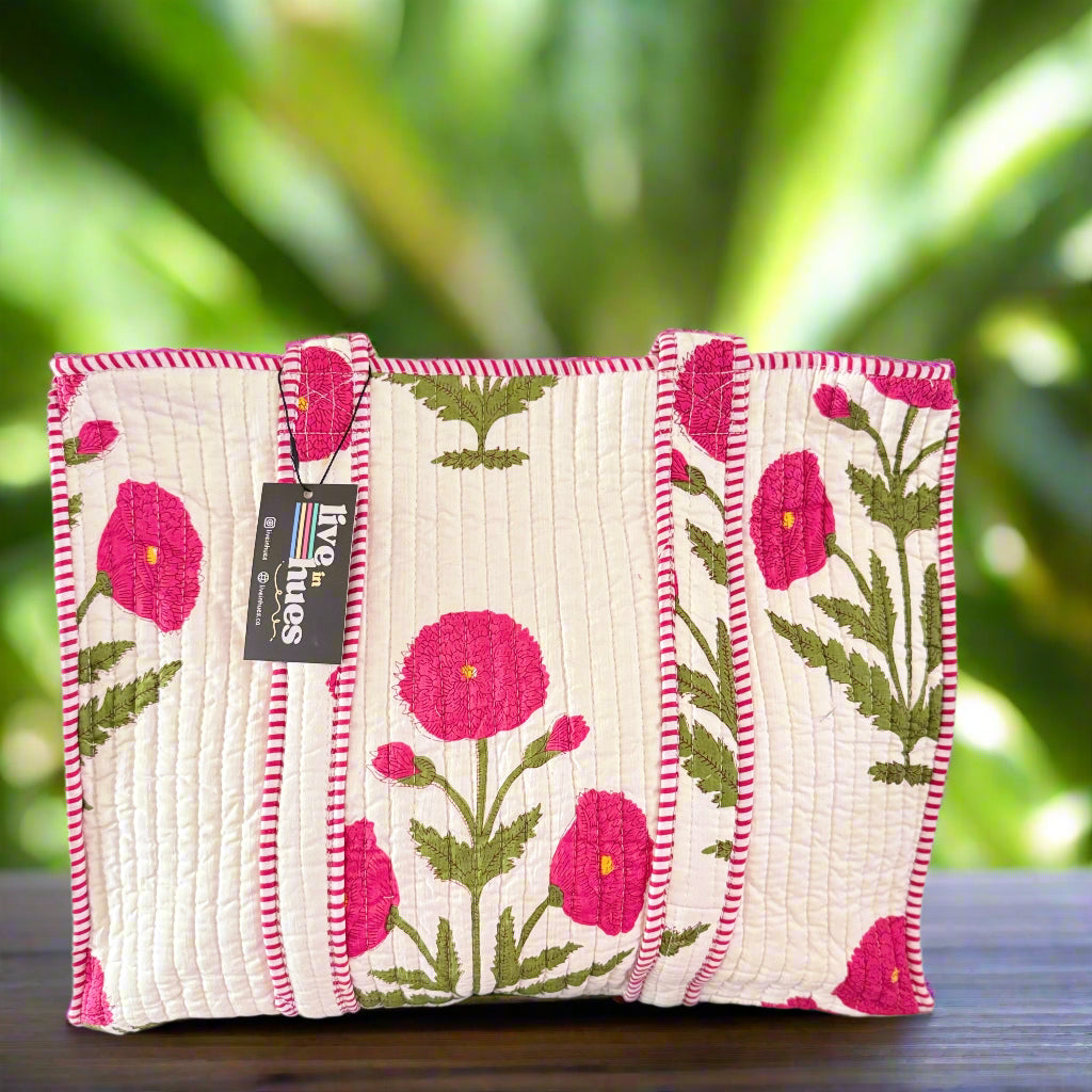 Floral-patterned fabric pouch with a visible brand tag on a neutral background