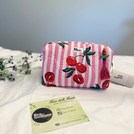 Pink striped pouch with cherry design on a white surface