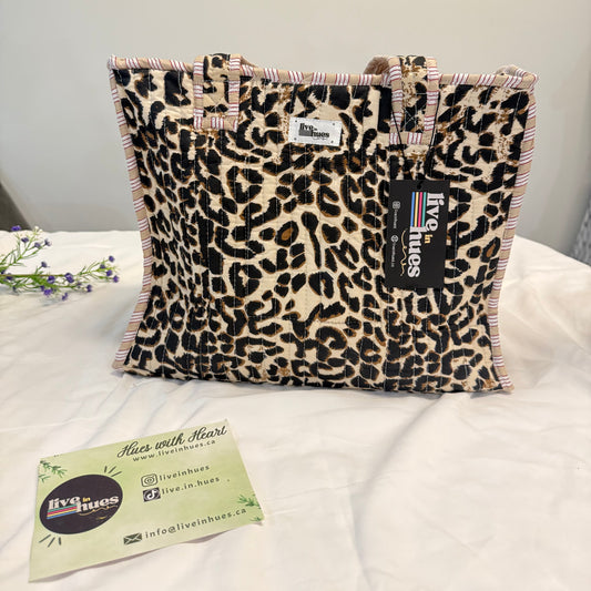 Leopard print bag with visible branding on a white surface