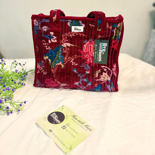 Floral-patterned handbag on a white surface with a visible brand tag.