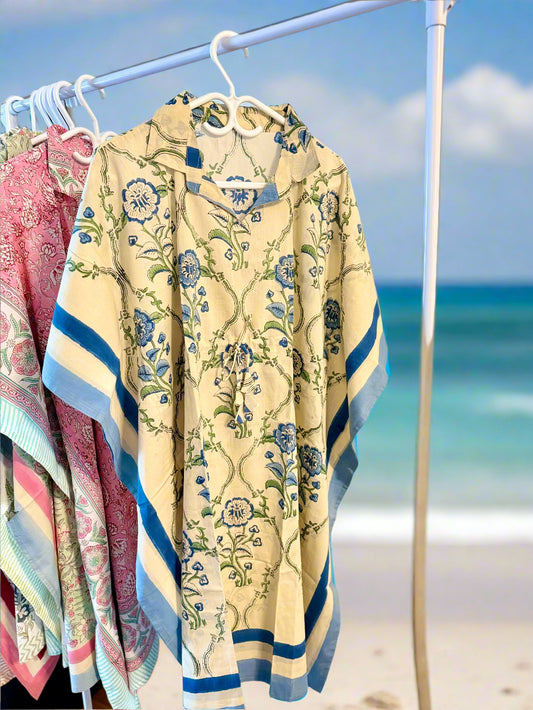 Floral-patterned cardigan on a rack with other clothing items