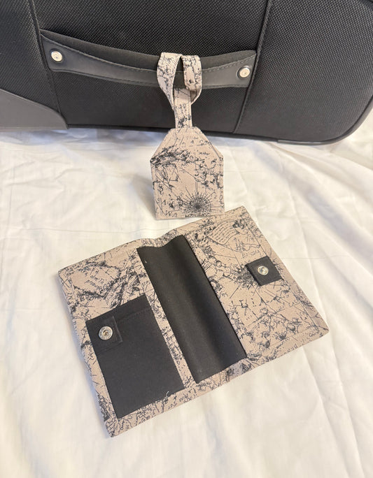 Travel accessory set with passport holder and luggage tag on a white surface