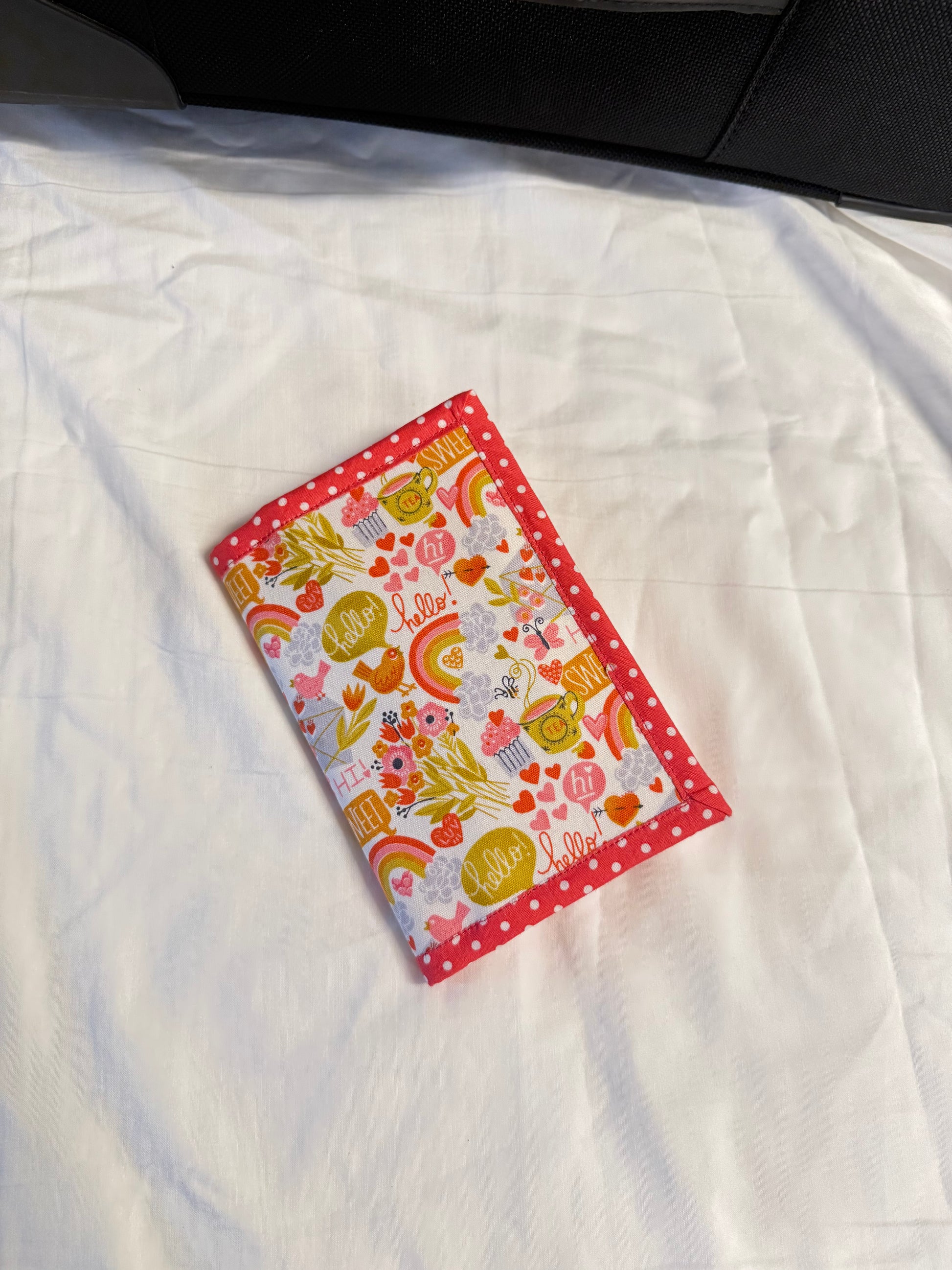 Colorful fabric patch with patterns on a white quilt