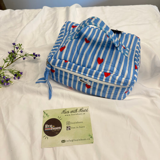 White comforter with a blue striped pouch and a label on a white background