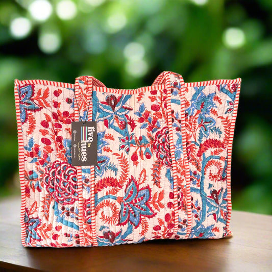 Floral-patterned tote bag with a visible brand label on a plain background