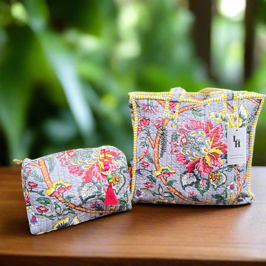 Two floral-patterned bags on a wooden surface with a blurred natural background