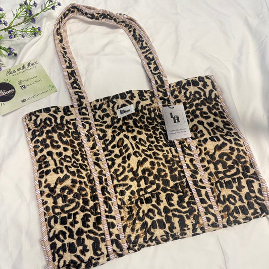 Leopard print bag with a strap on a white surface