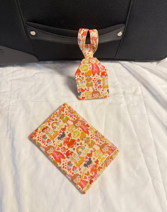 Floral patterned luggage tag and pouch on a suitcase with a white background
