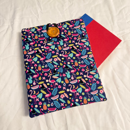 Colorful patterned pouch with a red interior on a white textured surface