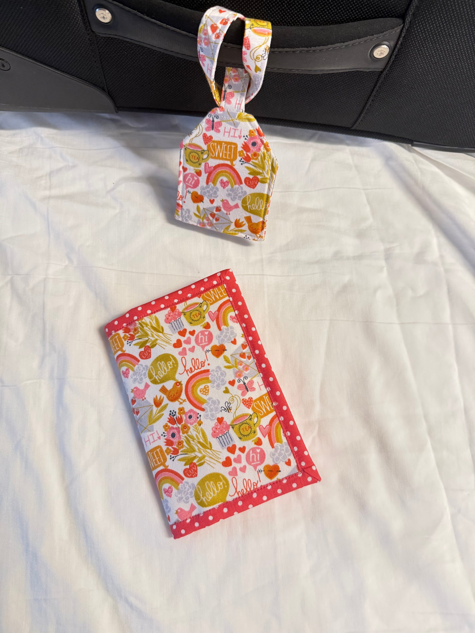 Fabric pouch with floral design on a white quilted surface