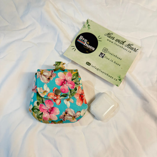 Floral-patterned product packaging on a white fabric background