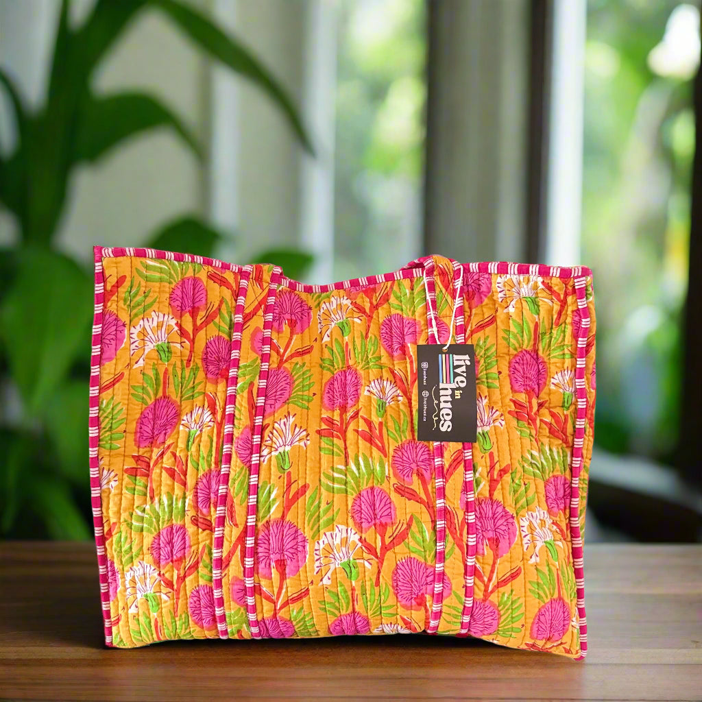 Colorful floral-patterned bag with a brand label on a white background