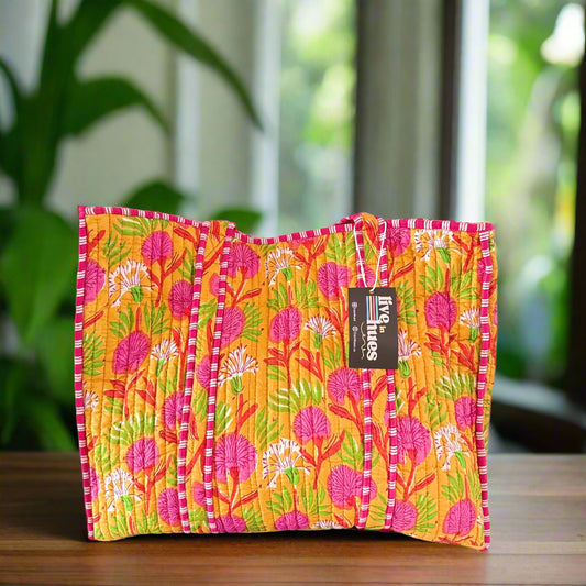 Colorful floral-patterned bag with a brand label on a white background